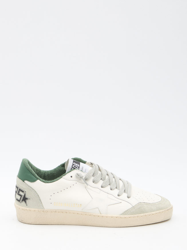 a white and green sneaker with a star on the side