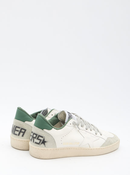 a pair of white and green sneakers on a white background