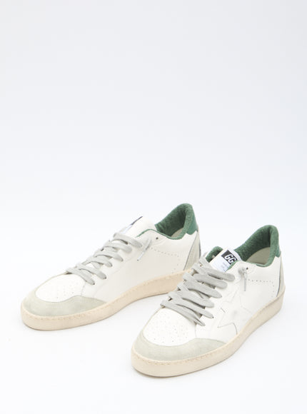 a pair of white and green sneakers on a white background