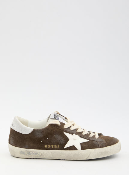 a brown sneaker with a white star on the side