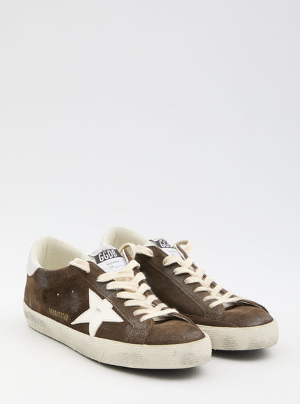 a brown sneaker with a white star on the side