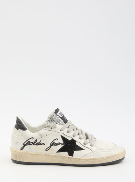 a white sneaker with a black star on the side