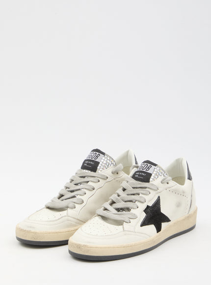 a white sneaker with a black star on the side