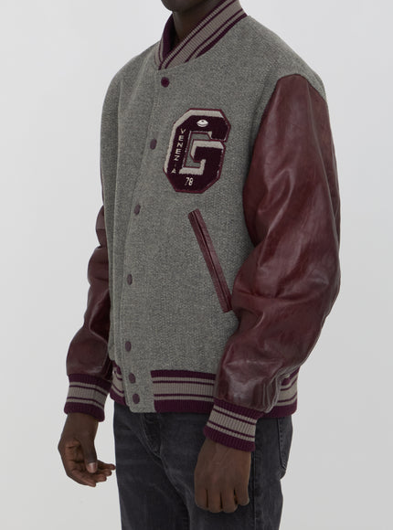 a man wearing a jacket with the letter g on it