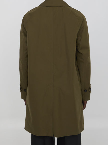 a man in a green trench coat