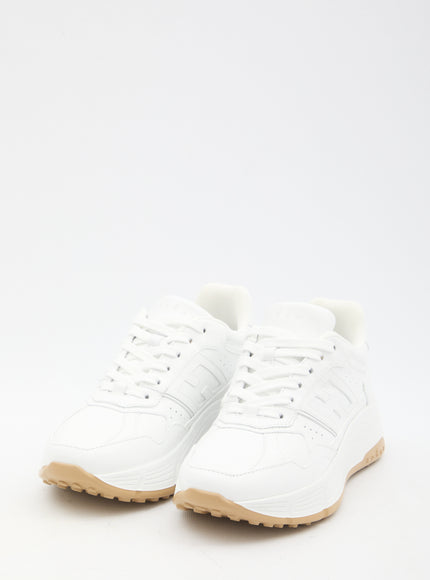 a pair of white sneakers on a white background