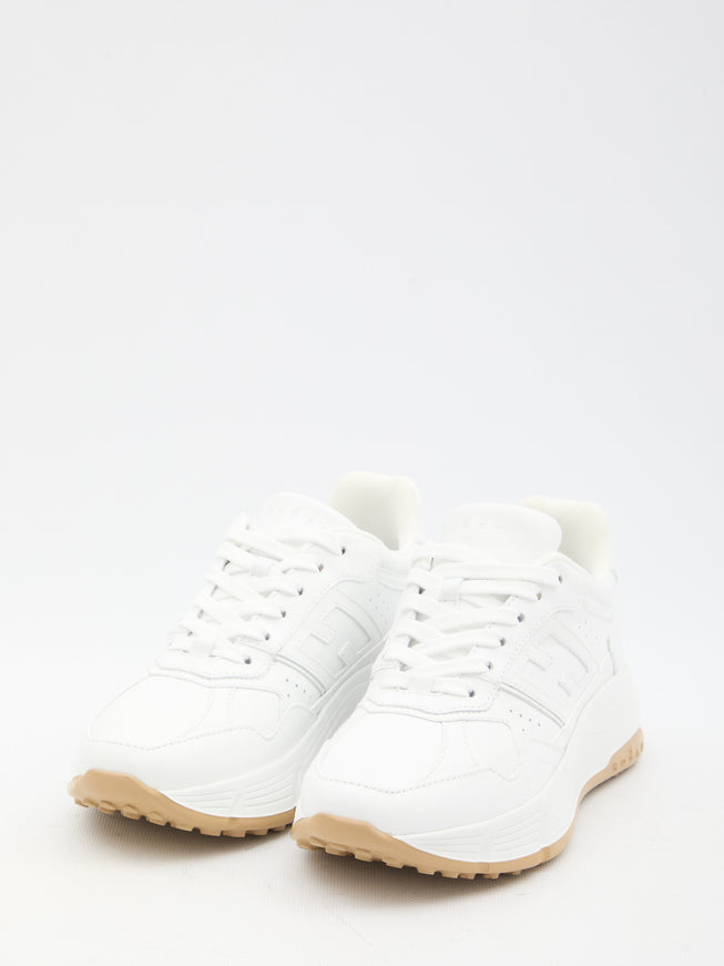 a pair of white sneakers on a white background