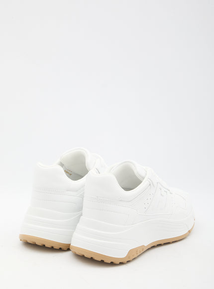 a pair of white shoes on a white background