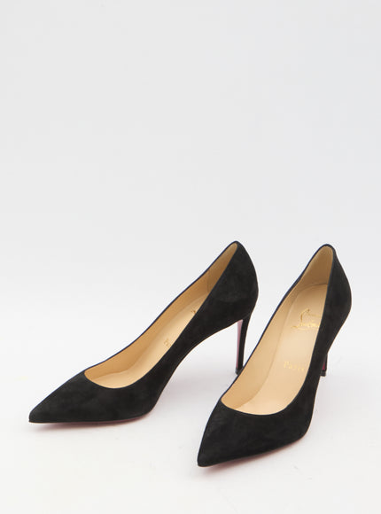 a pair of black high heels on a white surface