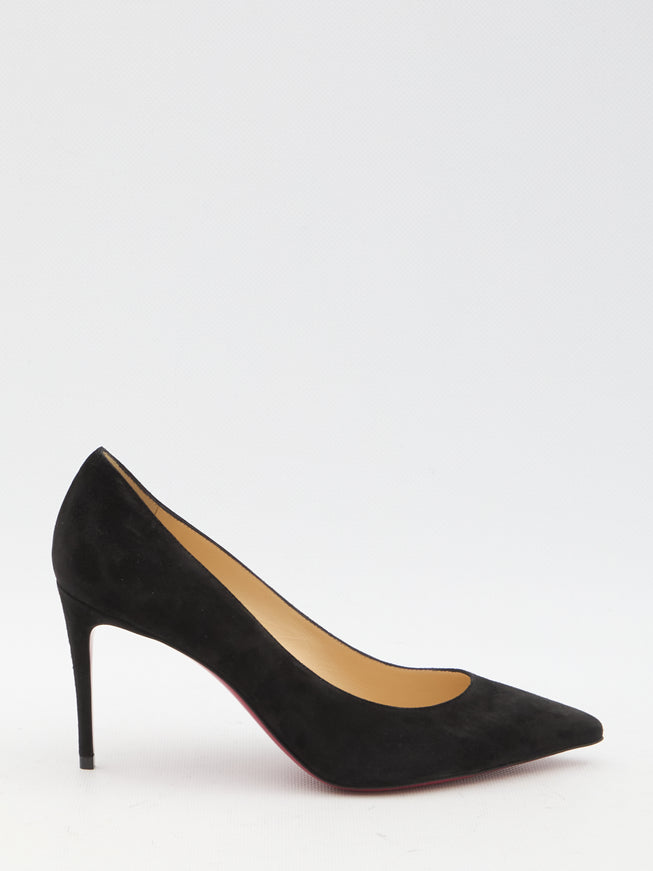 a woman's black high heeled shoe on a white background