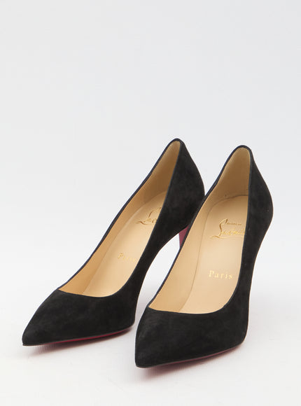 a pair of black high heeled shoes on a white surface