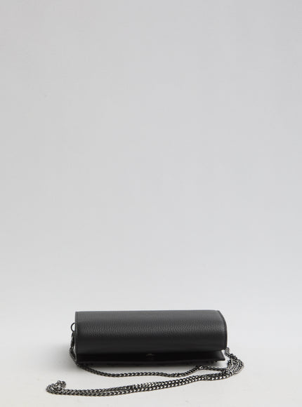 a black purse sitting on top of a white table