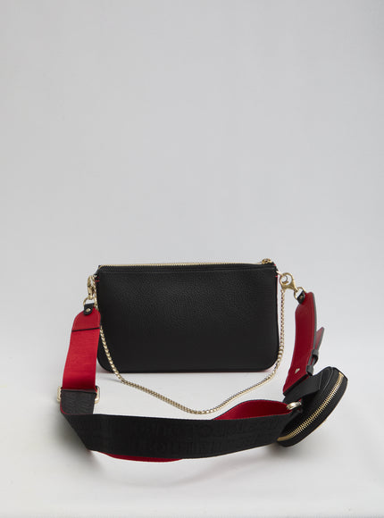 a black and red purse sitting on top of a white table