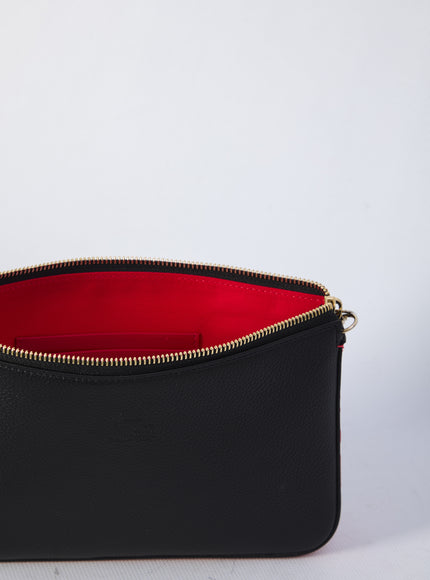 a black purse with a red lining on a white background