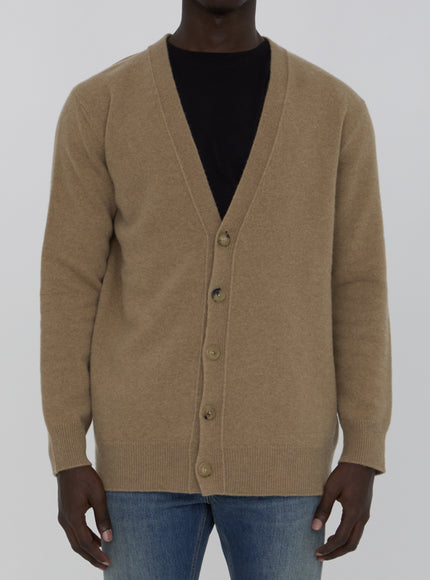 a man wearing a brown cardigan sweater and jeans