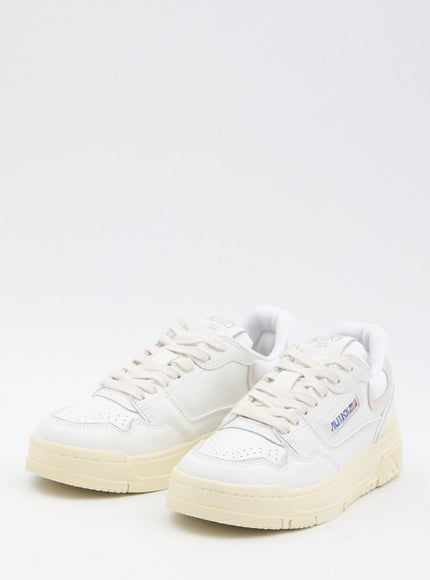 a pair of white sneakers on a white background