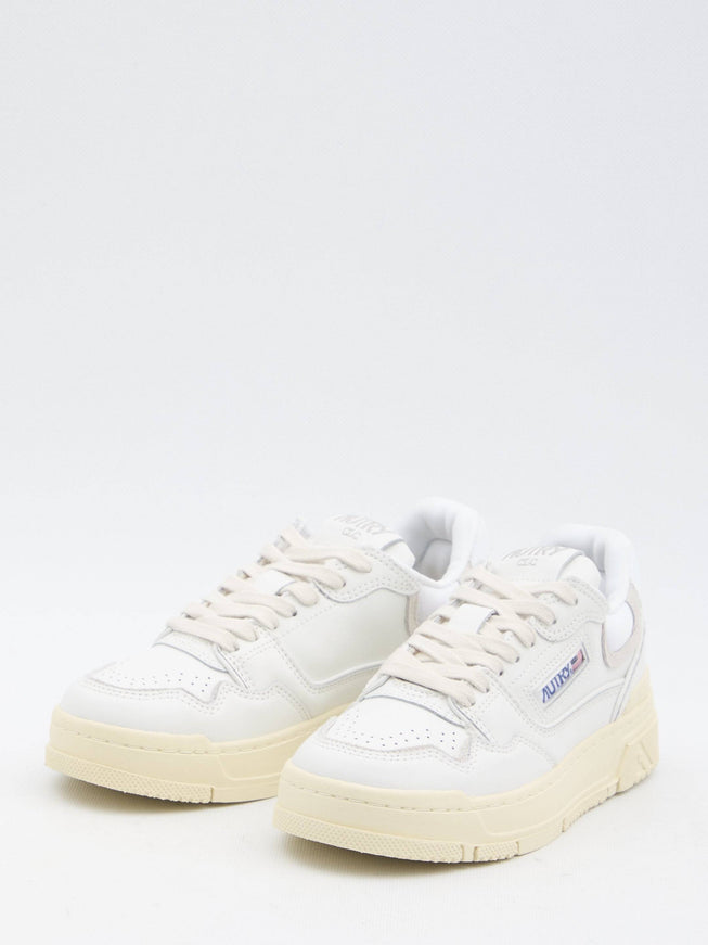 a pair of white sneakers on a white background