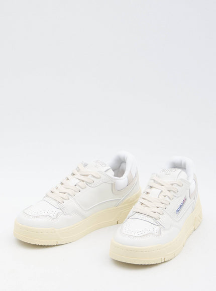 a pair of white sneakers on a white background