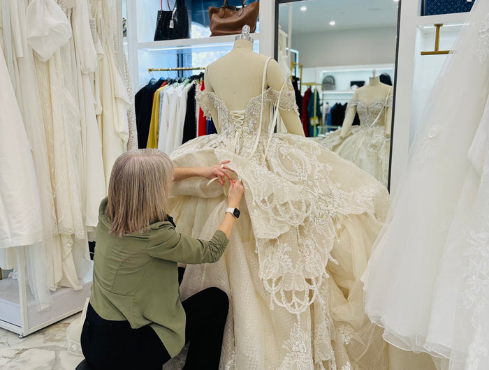 A tailor at Ellie Belle in Eden Prairie, working on a client's dress