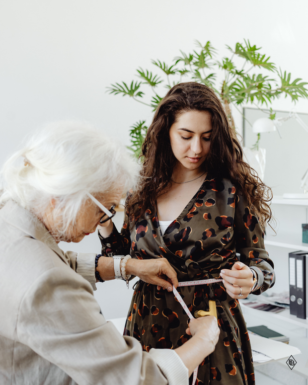Professional tailor fitting a client at Ellie Belle boutique in Eden Prairie.