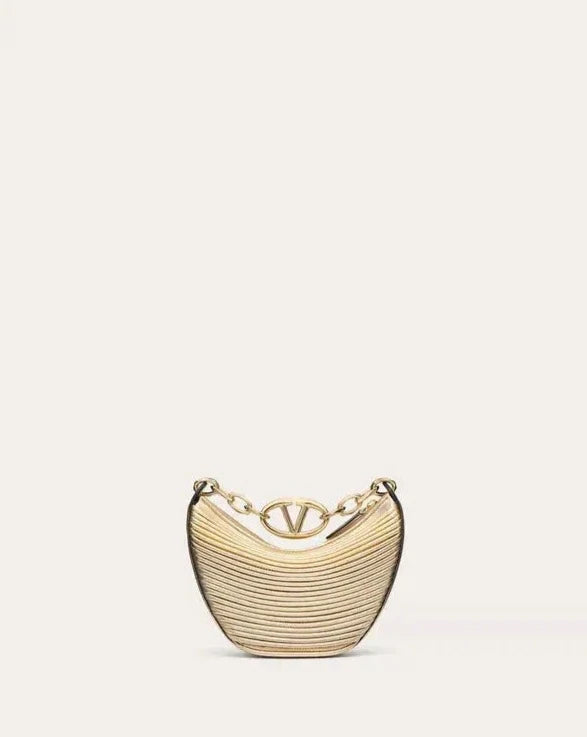 a gold purse with a chain hanging from it