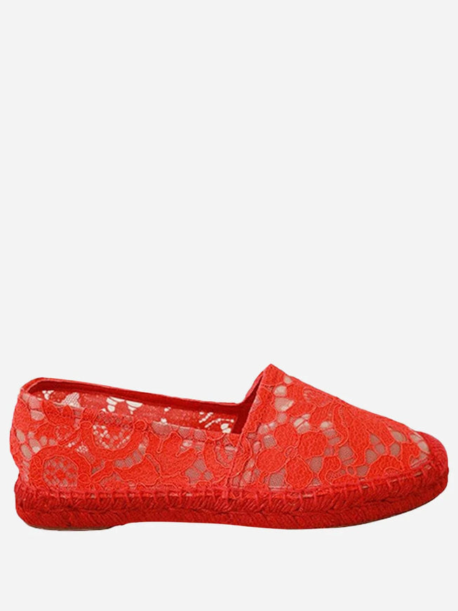 a pair of red shoes with lace on them