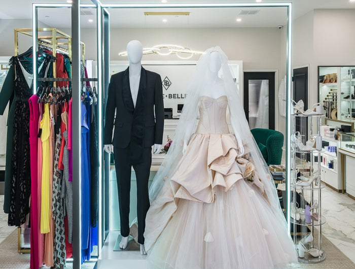 Wedding gown and men's suit displayed on a mannequin at Ellie Belle 