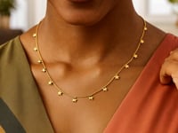 Collier en or jaune 14 carats avec étoiles pendantes