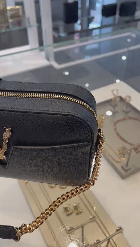 Close-up of Versace black Virtus bag with gold zipper and chain