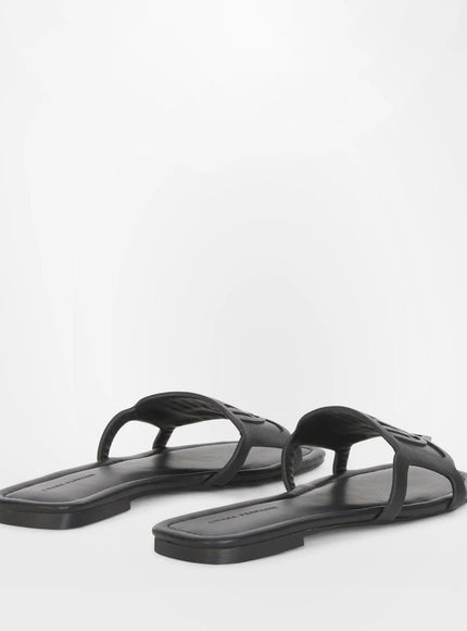 a pair of black sandals on a white background