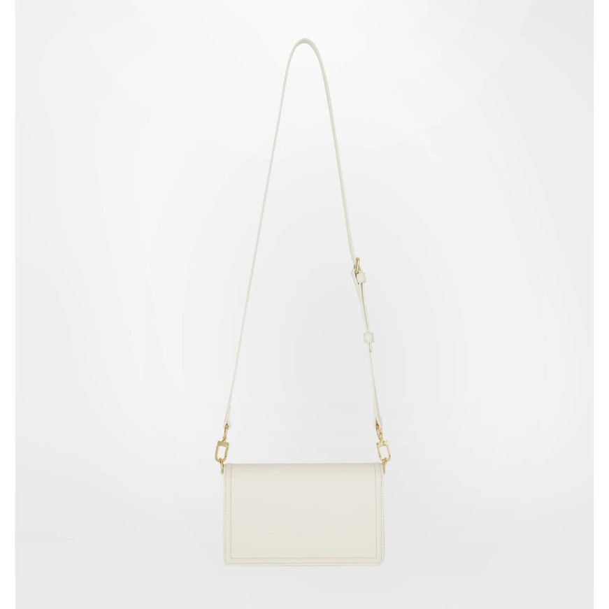 a white handbag with a long strap