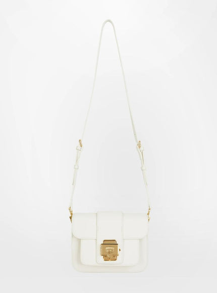 a white handbag with a gold buckle