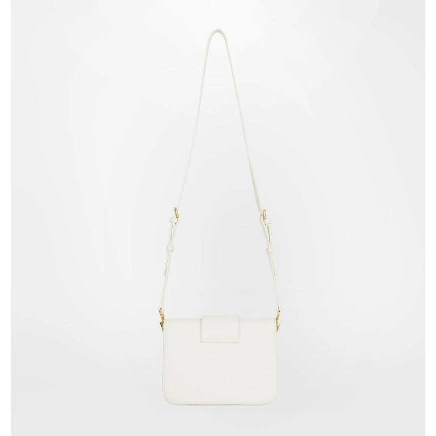 a white handbag with a long strap