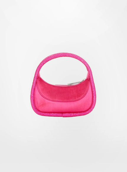 a pink handbag is hanging on a white wall