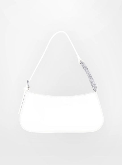 a white purse hanging on a wall