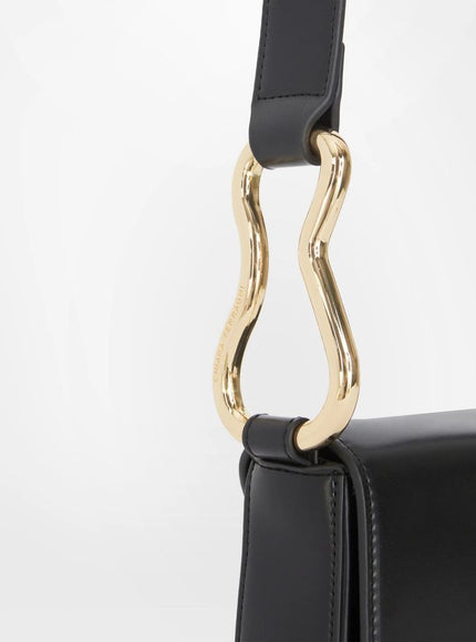 a black purse with a gold handle