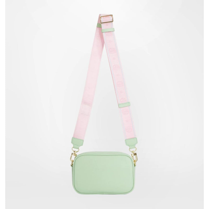 a small green bag with a pink strap