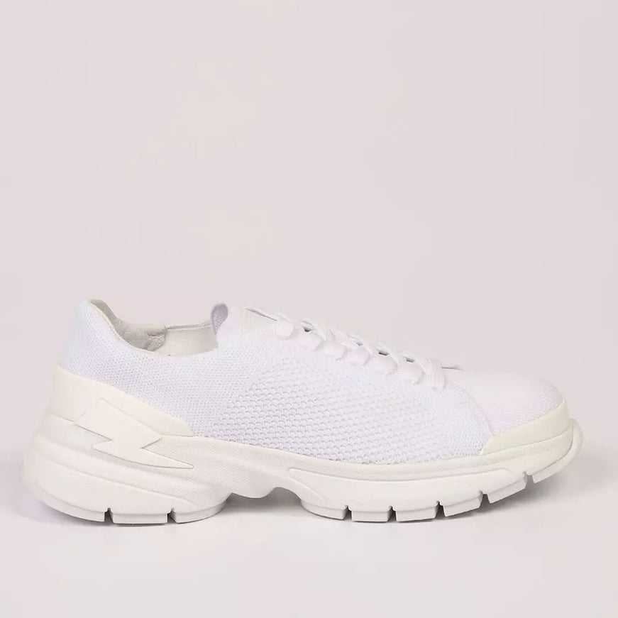 a woman's white sneaker with a white sole